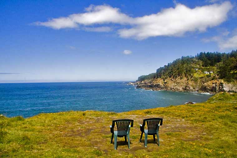 Two chairs of the bluff with ocean in background